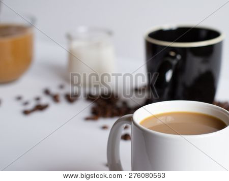 Blurred Angle Iew Of Cofffee Mug On White Table