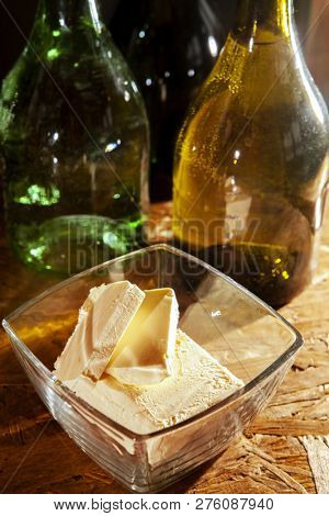 Butter in a plate and olive oil in bottles