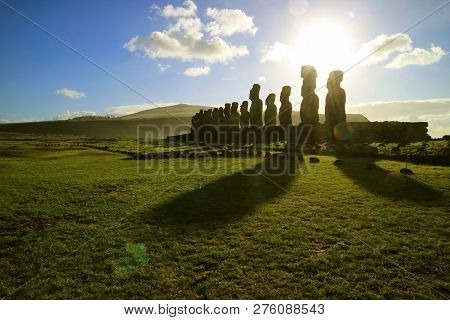 Silhouette Of Moai Statues Against Dazzling Sunrise Sky At Ahu Tongariki, The Largest Celemonial Pla