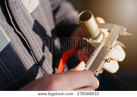 Plumber Measures The Diameter Of The Pipe With A Caliper Tap For Plumbing