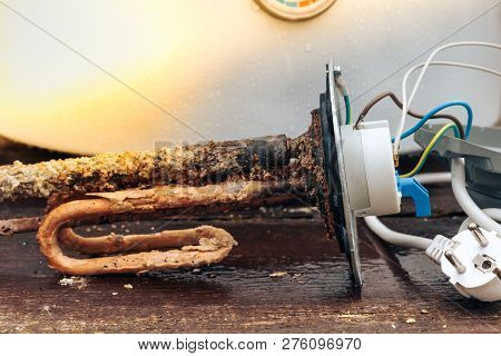 Disassembled Water Heating Tank On Wooden Background With Copy Space.