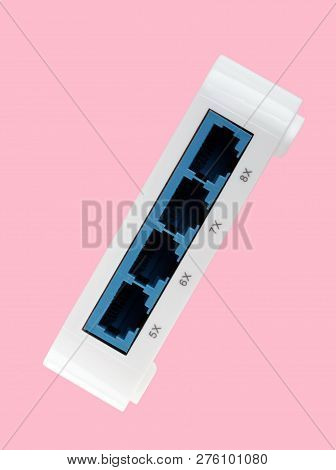 White 8 Port Plastic Ethernet Switch Isolated On Pink Background At Dry Day