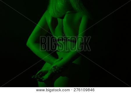 Woman In Belt With Hands Behind Back