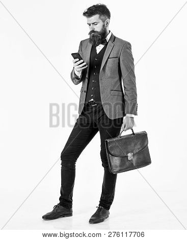 Brutal Man Looks Busy. Bearded Man Wears Smart Suit And Uses Smartphone. Guy With Serious Face, Fash