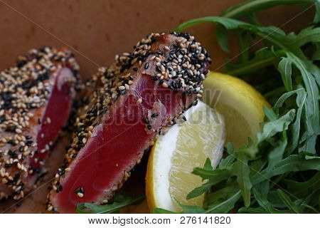 Close Up Street Food Brown Carton Box Portion Of Lightly Seared Tuna Steak With Sesame Seeds And Aru
