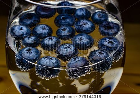Blueberries In Soft Drinks With Bubbles Closeup