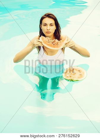 Young Sexy Woman Or Girl With Pretty Face And Long Hair Swimming In Pool With Blue Water In Wet Whit