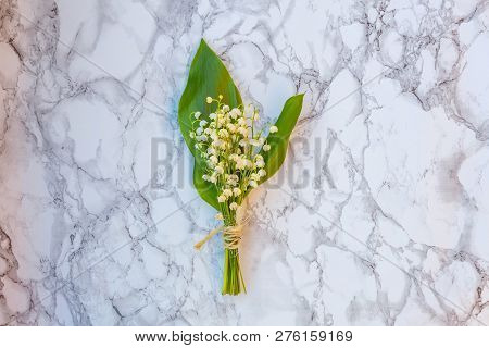 Bouquet Of Flowers Beautiful Smell Lily Of The Valley Or May-lily On Marble Background. Garden In Sp