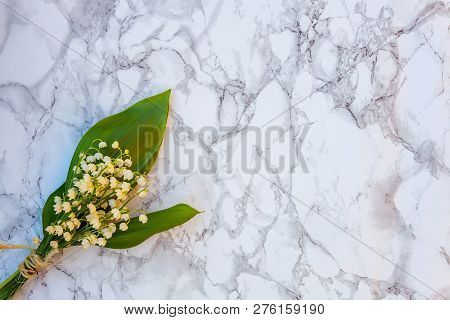 Bouquet Of Flowers Beautiful Smell Lily Of The Valley Or May-lily On Marble Background. Garden In Sp