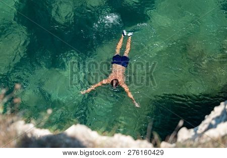 Profesional Swimmer In Holiday, Swimming Into The Sea In A Sunny Day In Turquoise Water On The Coast