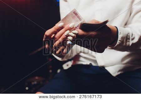 Russian Rubles In The Hand Of A Fan.male Hand Holding Many Of The Russian Banknotes.the Transfer Of 