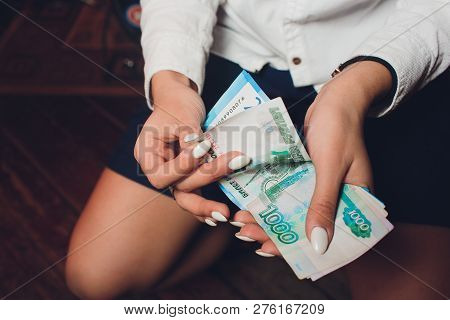 Russian Rubles In The Hand Of A Fan.male Hand Holding Many Of The Russian Banknotes.the Transfer Of 