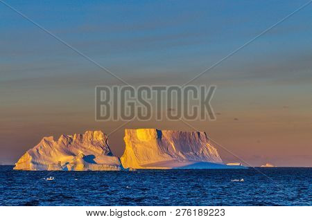 Antarctic Sunset: Floating Icebergs In The Weddell Sea, Near The Antarctic Peninsula, As Seen From A