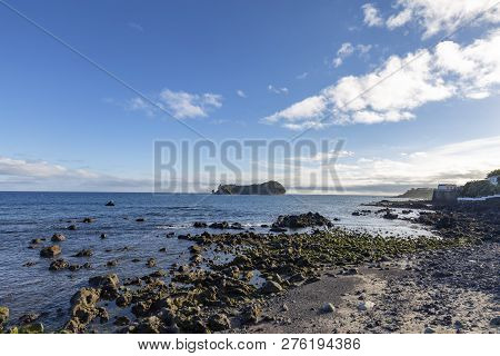 A Rocky Beach Looking Out At The Islet Of Vila Franca Do Campo.