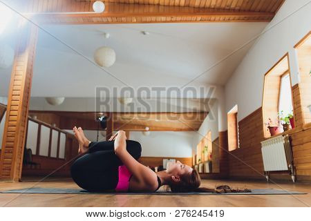 Sportswoman Focused On Stretch Before Pilates Class. Girl Doing Warm Up For Legs On Mat. Female Has 