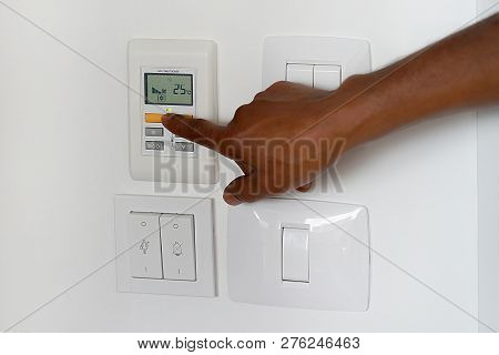 Male Hand Try To Turn On The New Air Condition In Room, In The Hotel Room. African Man Hands On The 