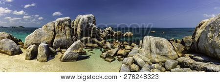 Panoramic View Of A Group Of Large Stones At Sea