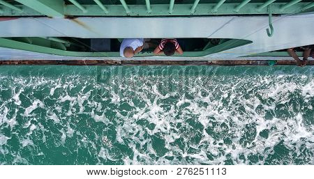 Penang - Malaysia / September 2016: Passengers Looking Through The Ferry Window During The Trip Betw