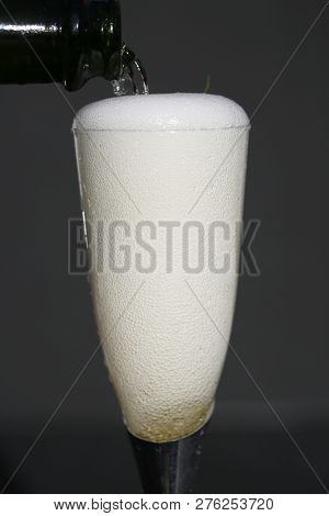 Champagne. Pouring Champagne into a glass. Glass of Champagne.