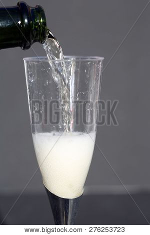 Champagne. Pouring Champagne into a glass. Glass of Champagne.