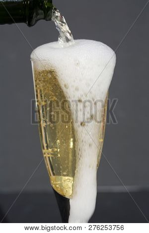 Champagne. Pouring Champagne into a glass. Glass of Champagne.
