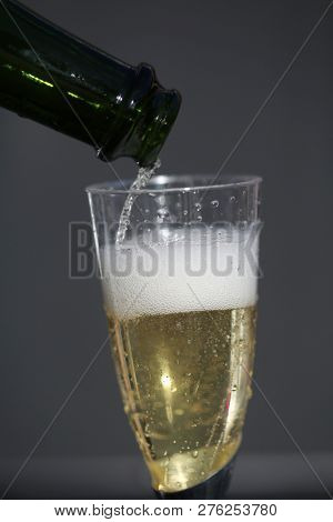 Champagne. Pouring Champagne into a glass. Glass of Champagne.
