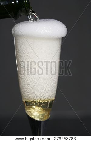 Champagne. Pouring Champagne into a glass. Glass of Champagne.