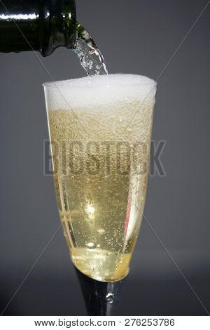 Champagne. Pouring Champagne into a glass. Glass of Champagne.