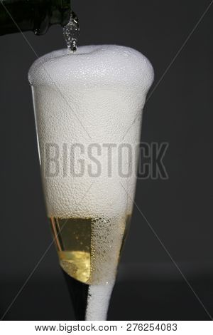 Champagne. Pouring Champagne into a glass. Glass of Champagne.
