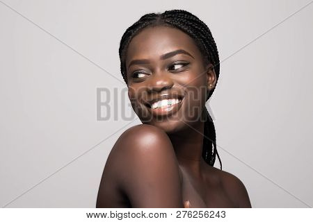Beautiful Exotic Woman With Dark Hair, Fresh Glowing Skin Face And Bare Shoulders Portrait.