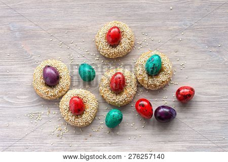 Traditional Greek Easter Cookies With Sesame Seeds And Colored Eggs On The Wooden Table, Selective F