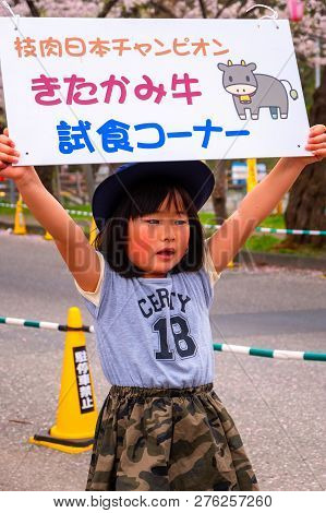 Iwate , Japan - April 22 2018: Unidentified Young Japanese Girl Holds Sign Selling The Kitakami Beef