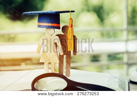 Back To School Concept, People Sign Wood With Graduation Celebrating Cap On Open Textbook With Light