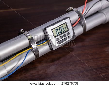 Pipe Bomb With An Clock Timer To Trigger Detonation, On Wooden Table
