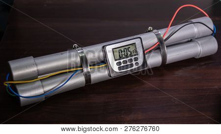 Pipe Bomb With An Clock Timer To Trigger Detonation, On Wooden Table