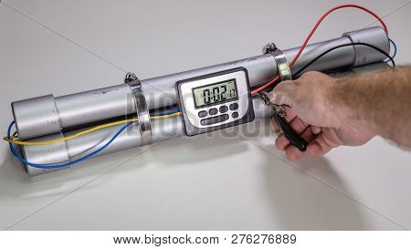 Hand Cutting Wire On Pipe Bomb On White Background