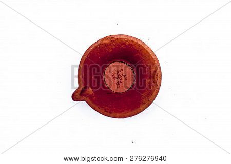 Close Up Of Lightening Lamps Or Diyas Or Divas Isolated On White Of Brown Color With A Swastik Or Sw