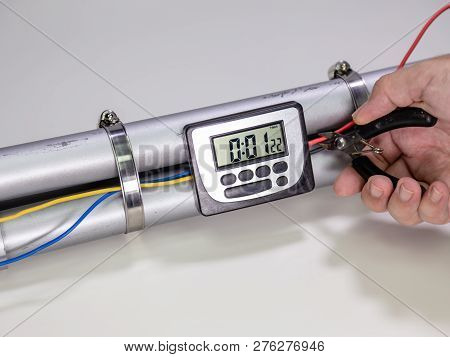 Hand Cutting Wire On Pipe Bomb On White Background