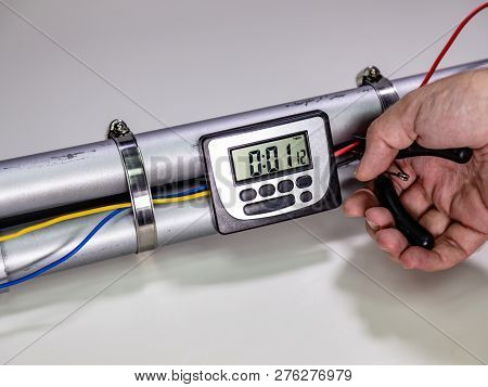 Hand Cutting Wire On Pipe Bomb On White Background
