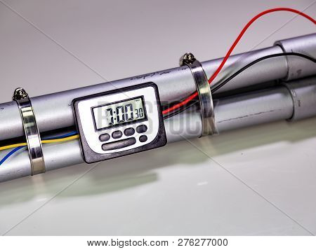 Pipe Bomb With An Clock Timer To Trigger Detonation On White Background