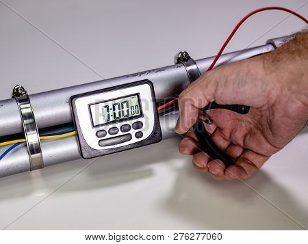 Hand Cutting Wire On Pipe Bomb On White Background