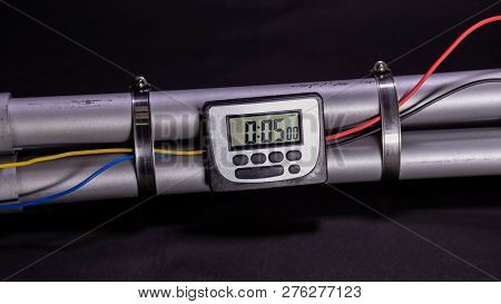 Pipe Bomb With An Clock Timer To Trigger Detonation On Black Background