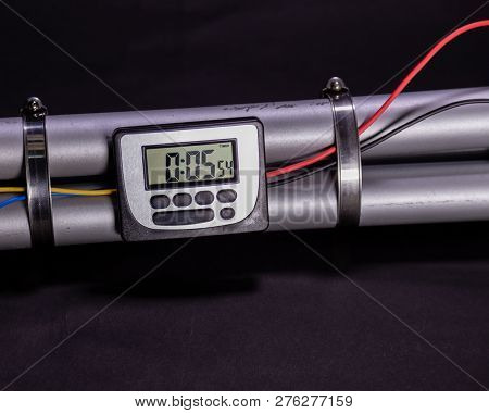 Pipe Bomb With An Clock Timer To Trigger Detonation On Black Background
