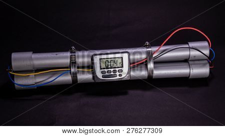 Pipe Bomb With An Clock Timer To Trigger Detonation On Black Background