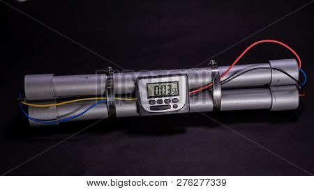 Pipe Bomb With An Clock Timer To Trigger Detonation On Black Background