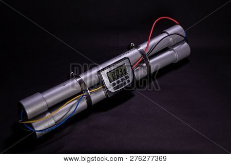 Pipe Bomb With An Clock Timer To Trigger Detonation On Black Background