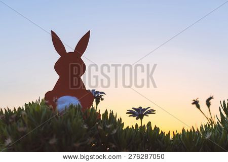 Creative Easter Photo Of Silhouette  Paper Rabbit In The Chamomile Flowers And Green Grass On The Su
