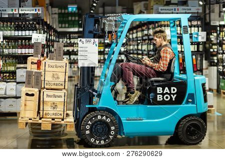 Kyiv, Ukraine, October 19, 2018. Hipster-looking Young Man Sitting In Electric Lift Truck Iside The 