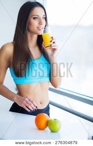 Diet And Haelth. Fit Smiling Young Woman With Healthy Juice In Modern Kitchen
