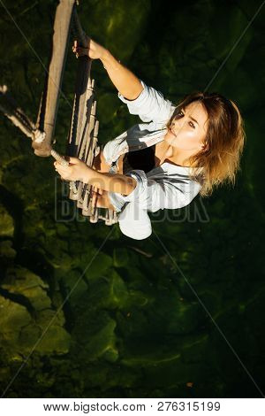 Achieving Her Towering Ambition. Sexy Woman Climbing Up Rope Ladder. Pretty Woman Climb Jacobs Ladde